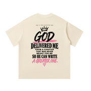 Back of mild apricot God Delivered Me oversized tee with black and pink statement print